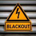 42 Dead After MASSIVE Grid Failure Yellow blackout warning sign with lightning bolt symbol
