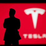 Silhouette with Tesla logo in red background.