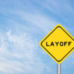 Yellow warning sign displaying the word 'LAYOFF'
