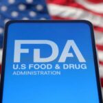 FDA logo displayed on a smartphone with an American flag background