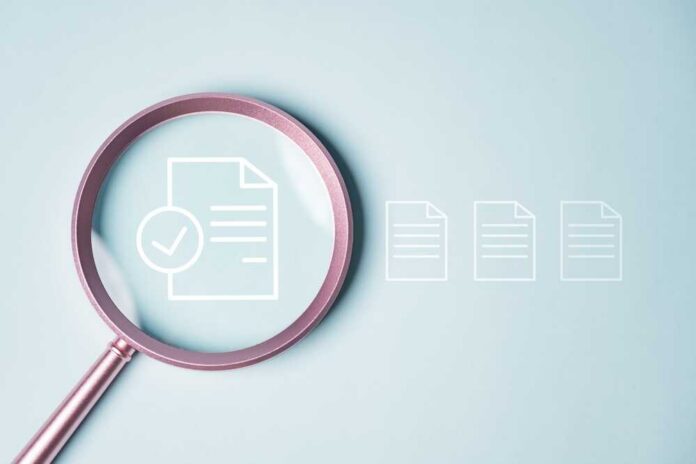 Magnifying glass focusing on a document with a checkmark