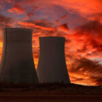 Nuclear power plant cooling towers at sunset.