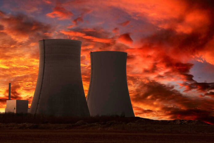 Nuclear power plant cooling towers at sunset.