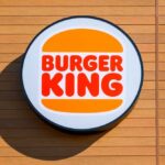 Burger King Surprises With Whopper Overhaul Burger King logo displayed on a wooden wall