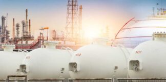 Gas storage tanks in an industrial facility during sunrise