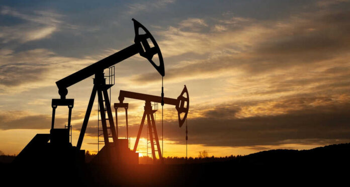 shutterstock_2283367131.jpg Oil pump jacks silhouetted against sunrise sky
