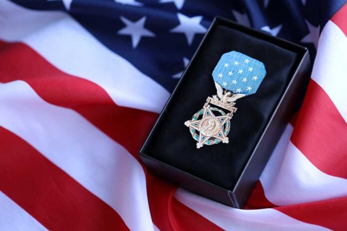shutterstock_2514301307.jpg A military medal displayed on a black box with an American flag background