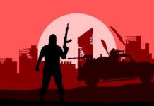 Silhouette of a soldier with a weapon against a red sunset and a military vehicle
