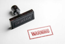 Rubber stamp with warning text imprint