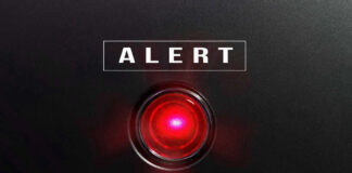 Red alert light against black background, text ALERT.