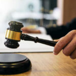 Gavel in judges hand about to strike.