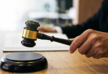 Veterans Sue to Block Trump’s Controversial Arch Gavel in judges hand about to strike.