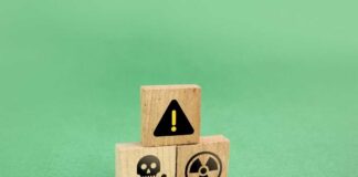 Wooden blocks displaying hazard symbols including a skull, radiation, and an exclamation mark