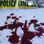 Lurid Allegations: Music Star Linked to Teen Murder Blood stains on a surface with police caution tape in the background