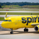 Yellow airplane on airport runway.