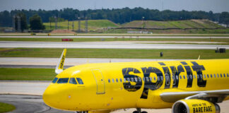 Yellow airplane on airport runway.