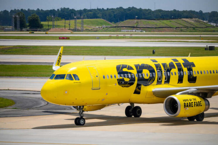 shutterstock_1480478327.jpg Yellow airplane on airport runway.
