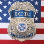 ICE AGENT’s Shocking Twist – Assault Charges! ICE officer badge displayed against an American flag background