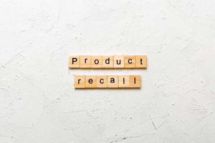 shutterstock_2450452315.jpg Wooden letter tiles spelling 'Product recall' on a textured surface