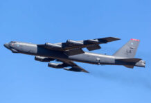 B-52 bomber flying against a clear blue sky