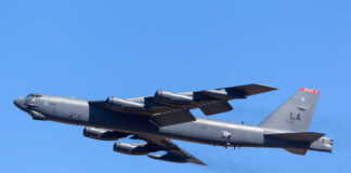 B-52 bomber flying against a clear blue sky