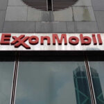 Oil Price Warning From Exxon ExxonMobil logo displayed on a glass building