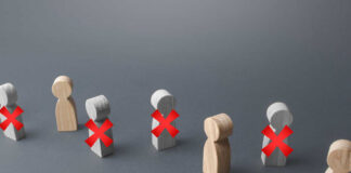 Wooden figures representing people with red crosses indicating exclusion