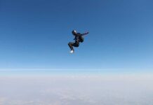Skydiver in freefall against a clear blue sky