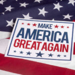 MAGA Pastor Implodes Overnight Sign saying Make America Great Again on American flag.