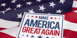 Sign saying Make America Great Again on American flag.