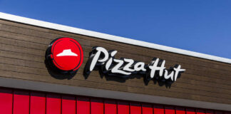Pizza Hut restaurant sign against a clear blue sky