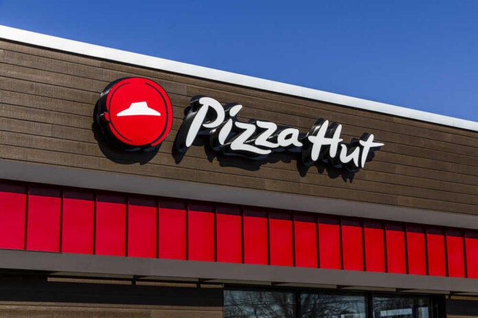 Pizza Hut restaurant sign against a clear blue sky